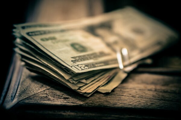 A pack of bills on a wooden table