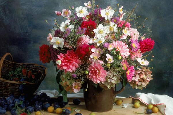 Still life with a bouquet of flowers and fruits