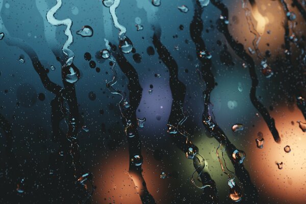 Drops of water run down the fogged glass