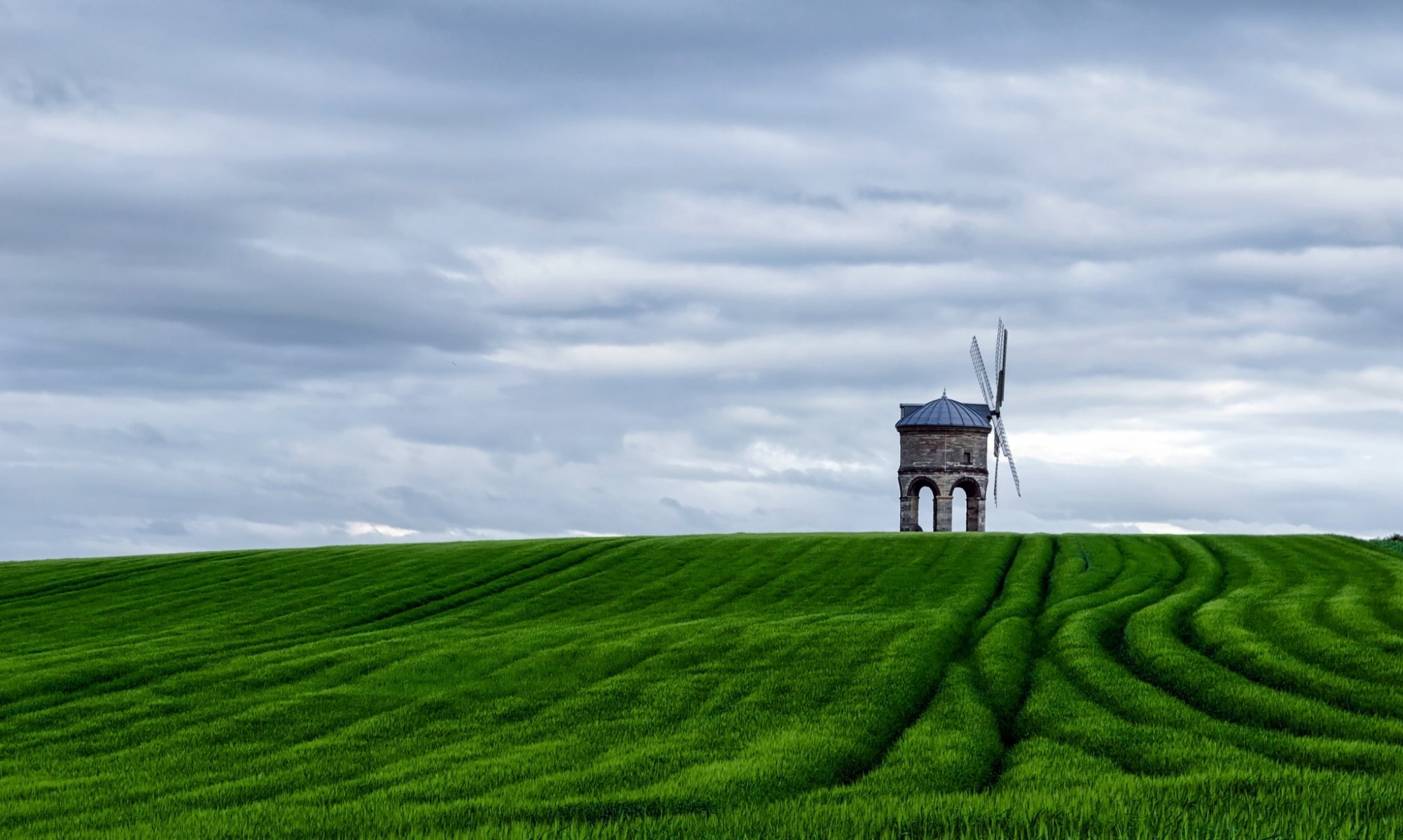 mill the field green sky clouds landscape