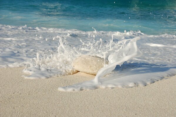 A stone on the beach, washed by the ocean