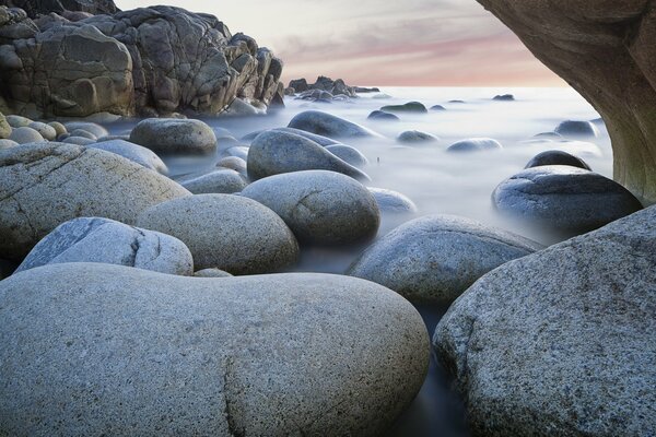 Smooth stones and fog over the sea