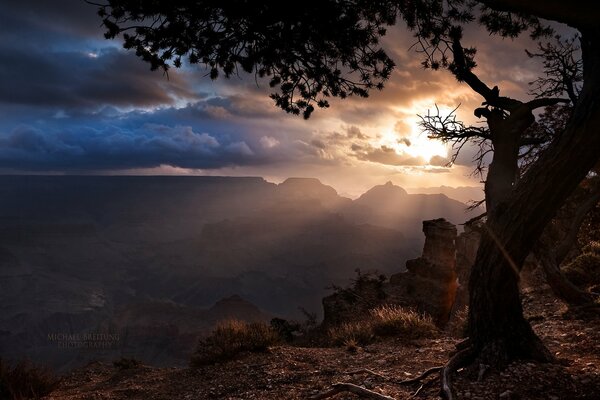 The sun s rays break through to the tops of the canyons