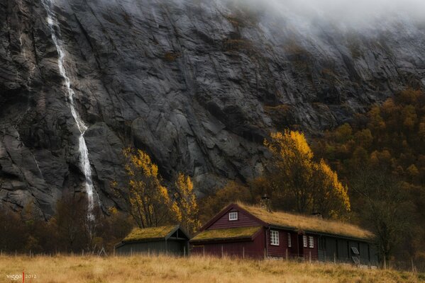 Norwegian house and waterfall nearby