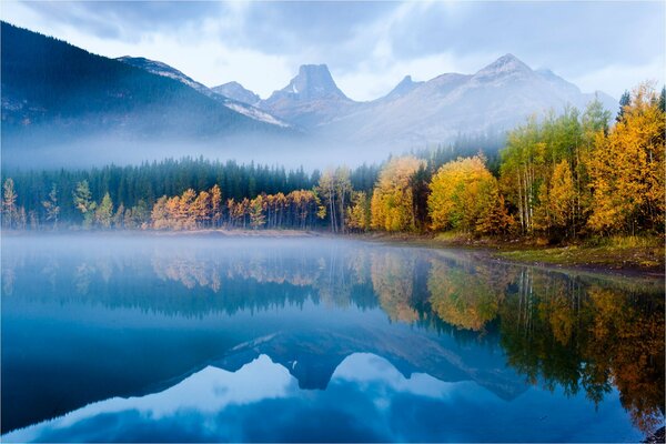 The peaks are reflected in a mountain lake