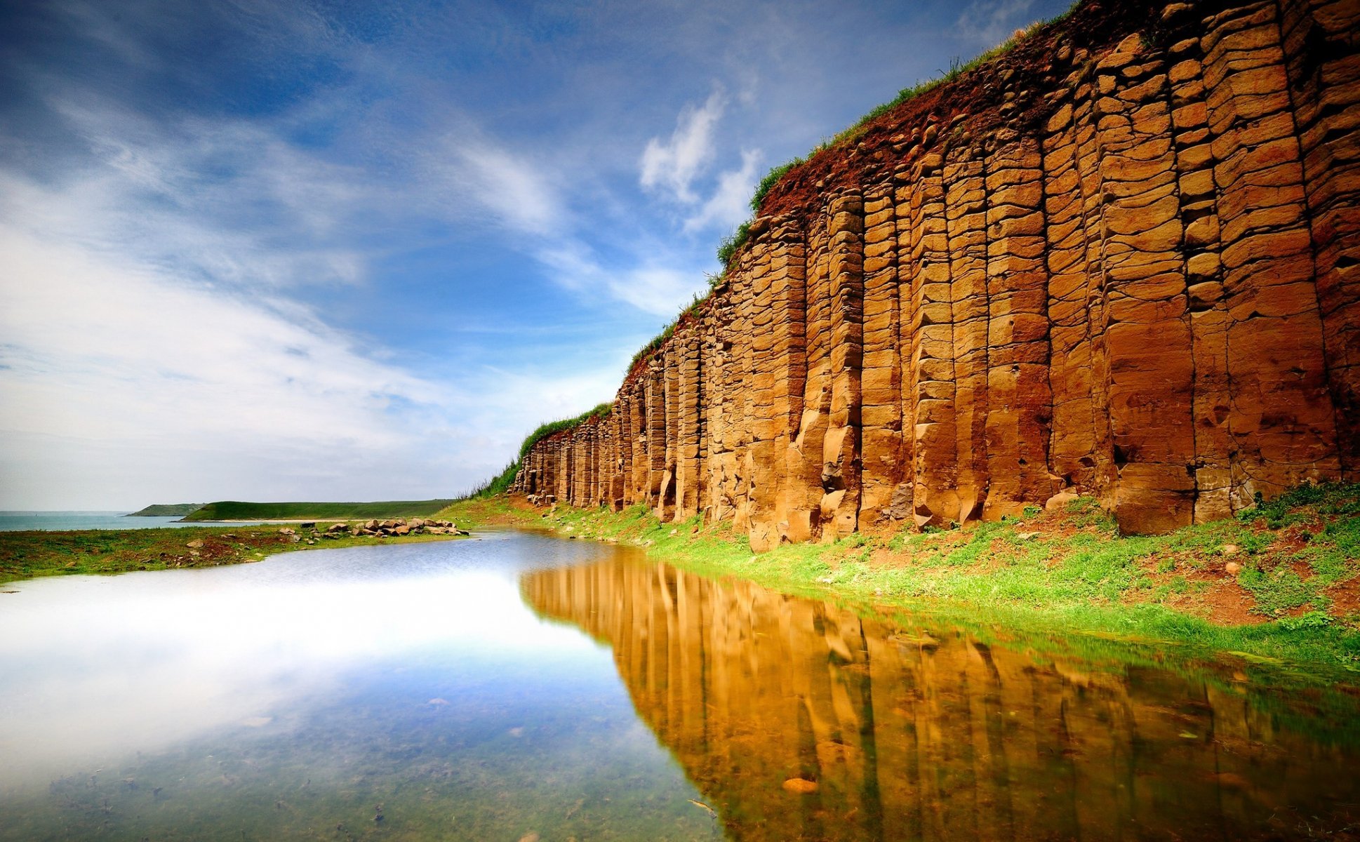 water lake wall hill sea reflection surface of green gra