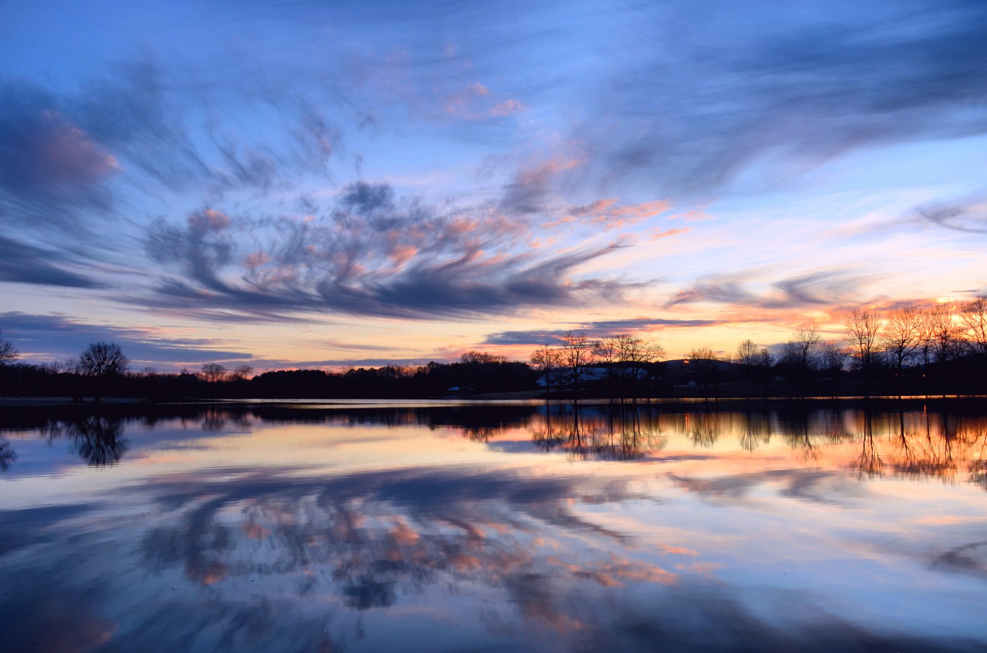 night orange sunset sky clouds tree river water surface of reflection