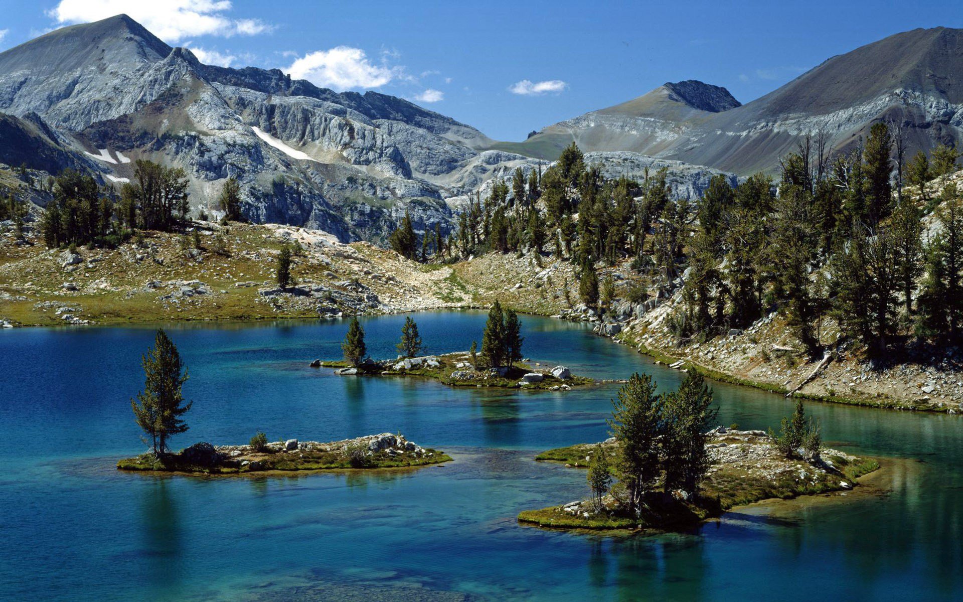 rocas montañas picos pendiente bosque árboles río cauce islotes corriente islas cielo nubes