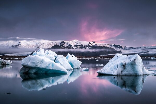 Sommets blancs des montagnes. Blocs de glace au premier plan