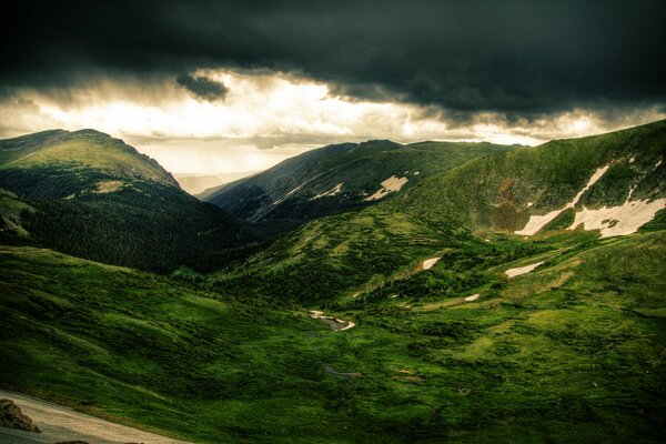 Thunderclouds over green hills