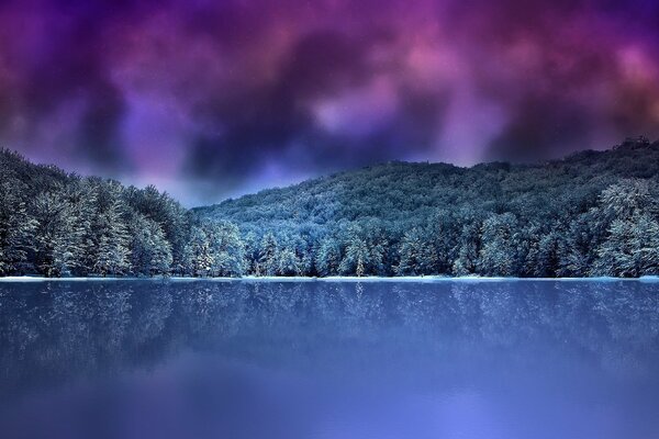 Forest mountains on the background of the lake and the night sky