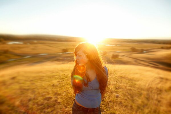 A girl in a field in the sun