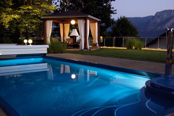 Gazebo with a swimming pool on a landscape background