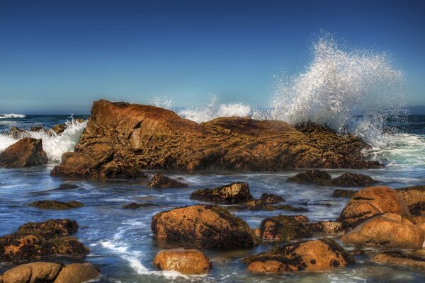 Splashes of waves on rocks in the sea