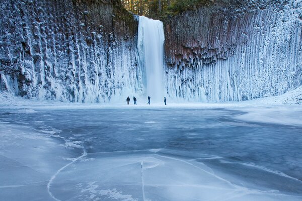 Four travelers and a frozen waterfall