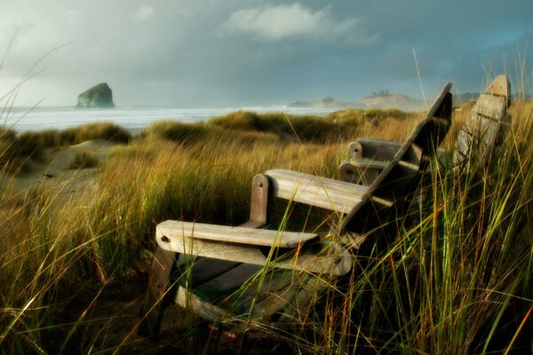 Wooden chairs on the shore of the reservoir