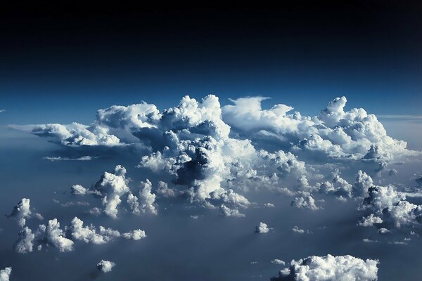 Cumulus white clouds on a blue sky background