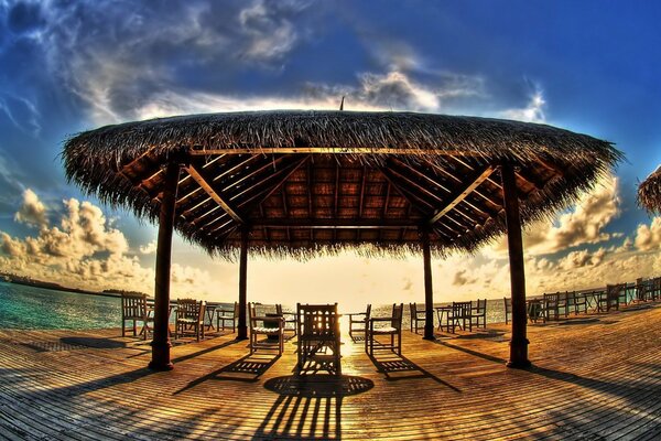 Tables under a canopy on the ocean