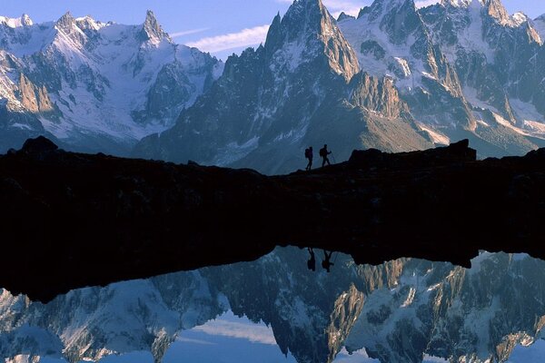 Mountains with snow-capped peaks and a lake at the foot