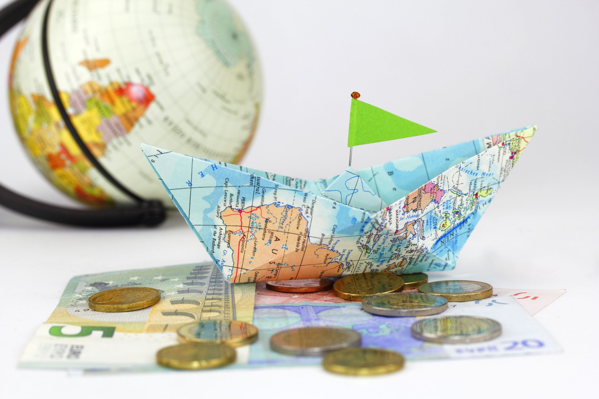 navigation composition globe map paper boat coins paper money creative positive travel good idea blurriness bokeh wallpaper