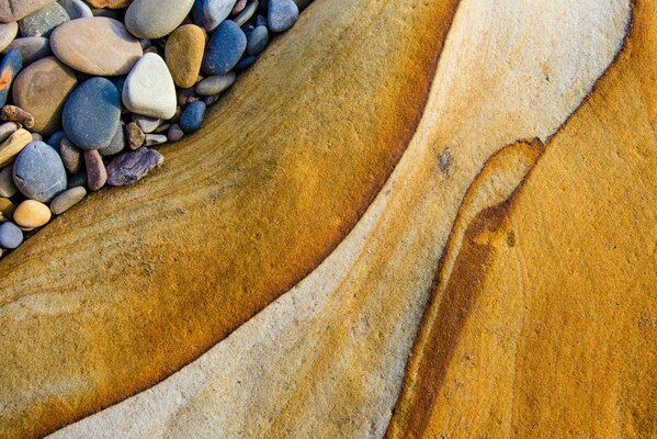 Colorful pebbles next to a large cobblestone