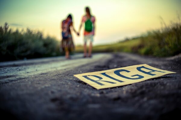 A sign on the background of a couple on the road