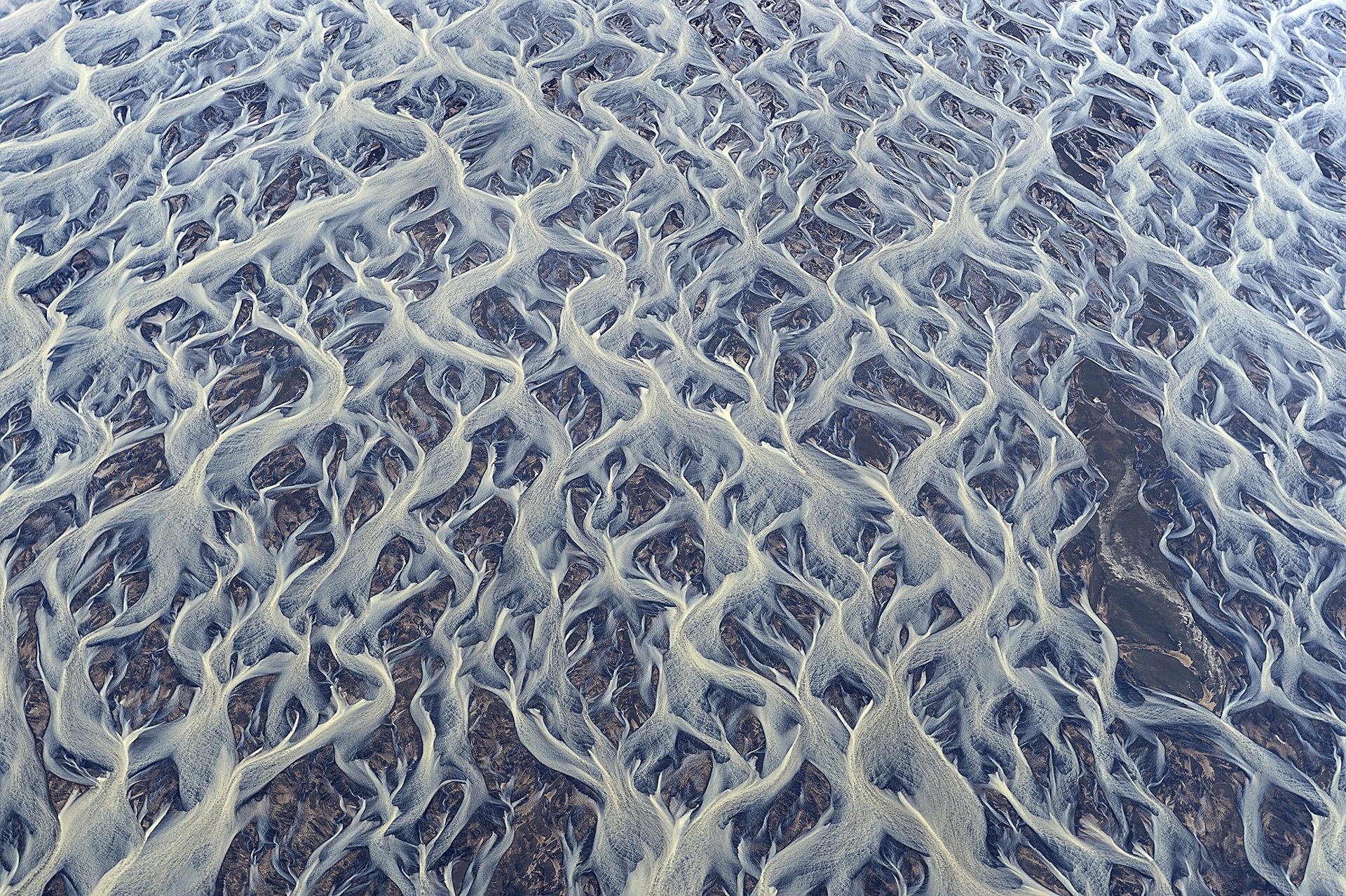 iceland abstract landscape river streams flows volcanic ash glacial mud textures patterns top view