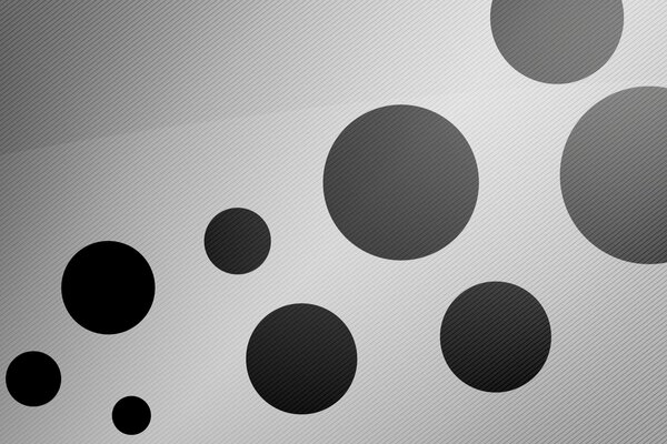 Black circles of different sizes on a white background