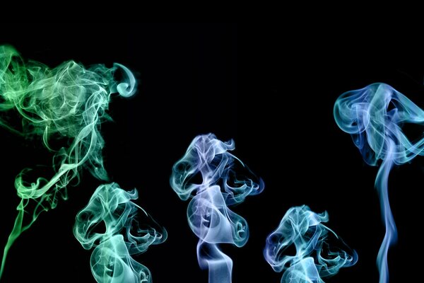 Green and blue smoke on a black background