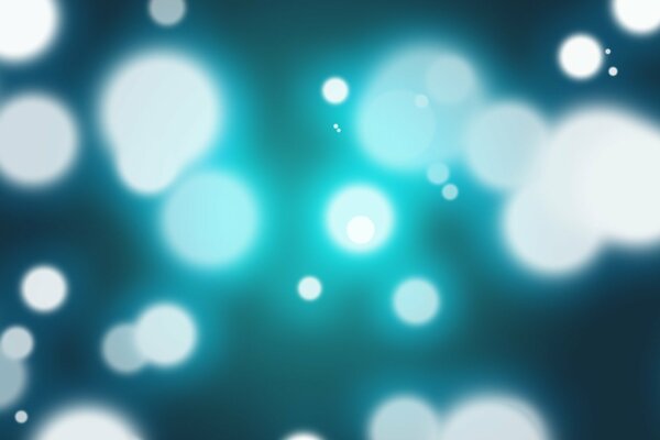 Abstract blue-white spots on a dark background