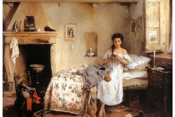 A young girl is sitting in a nightgown on a bed among the mess and looking at a photo