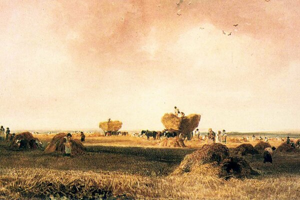 A picture of people in a field with carts of hay