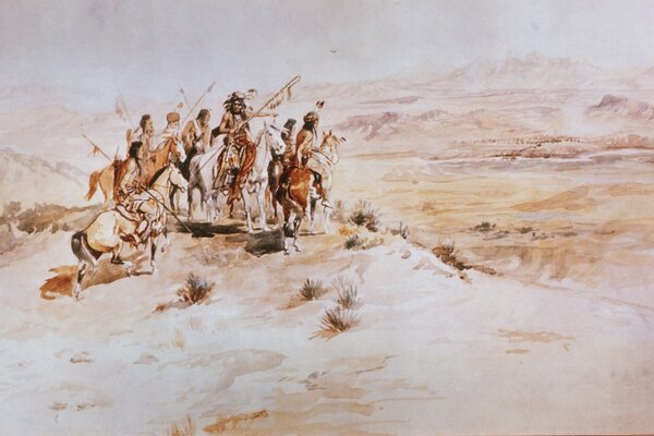 People with guns on horseback in the desert