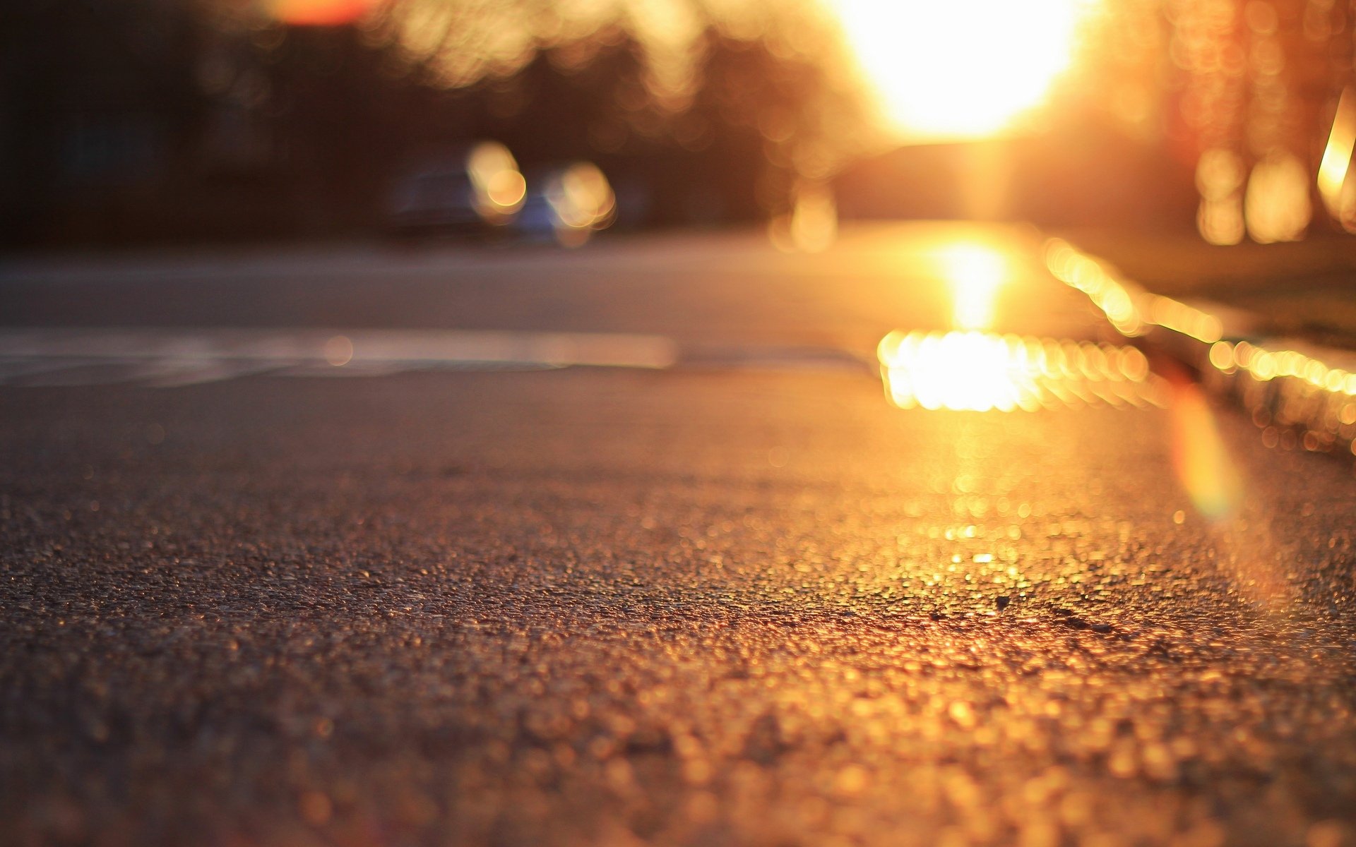 close up land asphalt sun rays bokeh blur background wallpaper widescreen full screen hd wallpaper