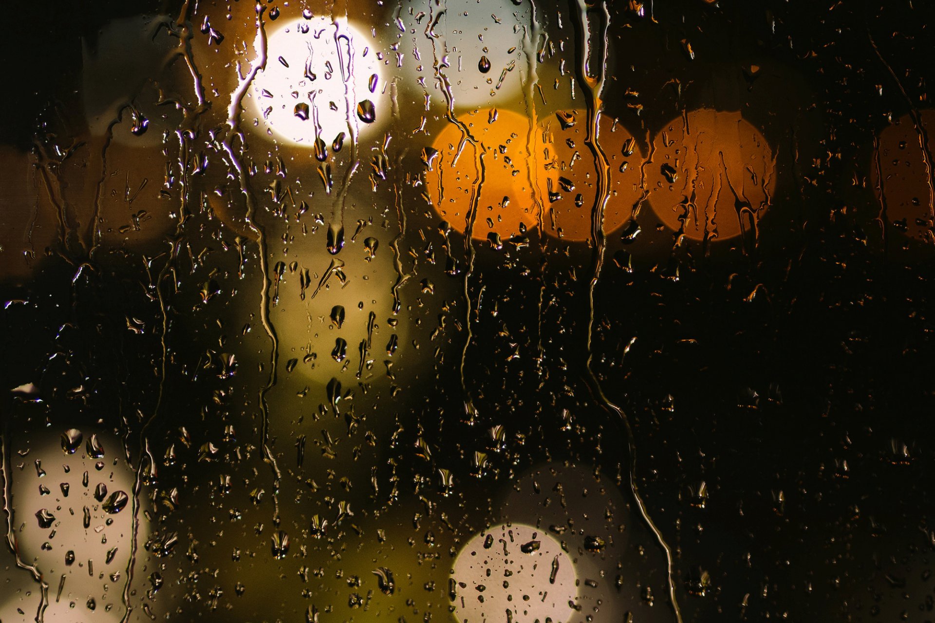 close up bokeh lights orange yellow glass drops water rain