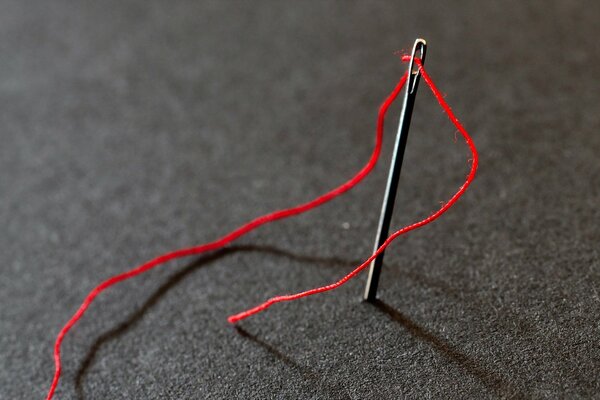 Enlarged needle with red thread