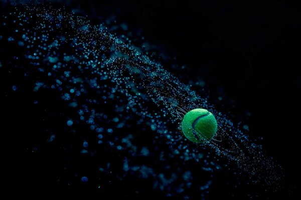 Photo of a green ball in flight, splashes