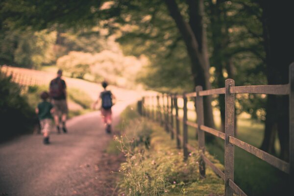 The morning journey of a father with children to school