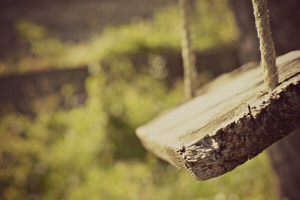 Homemade swing on the grass for childhood