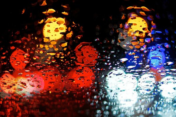 Bright lights behind wet glass