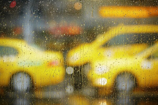 View of the rainy city from behind the glass