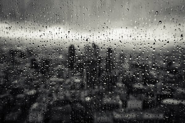 Rainy day outside the window of a gray city