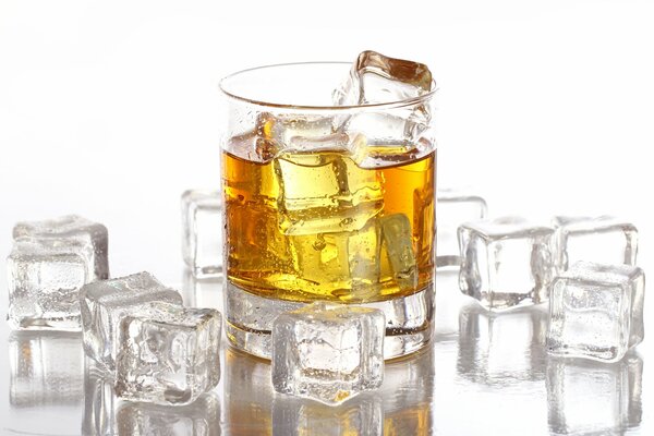 A glass of whiskey with ice cubes