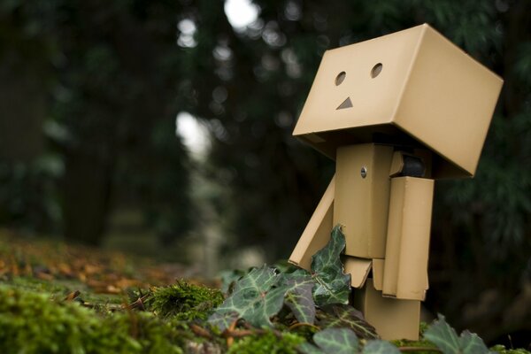 Wooden doll in the summer forest