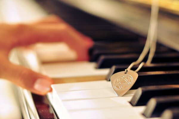 Photo of piano keys with a medal