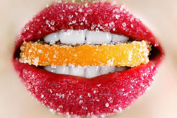 Citrus piece in white teeth and sugar lips