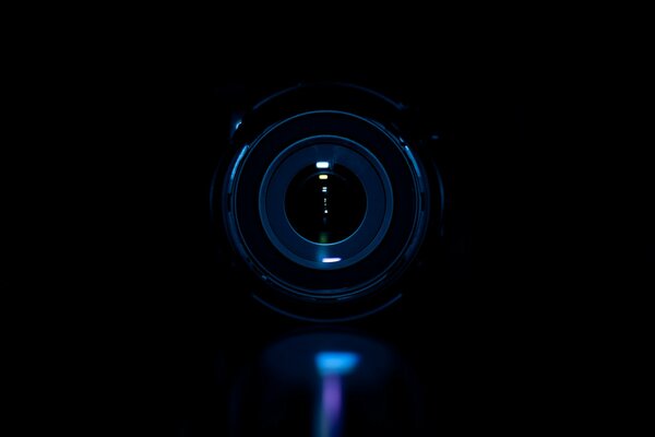 Photo of a camera lens in the dark