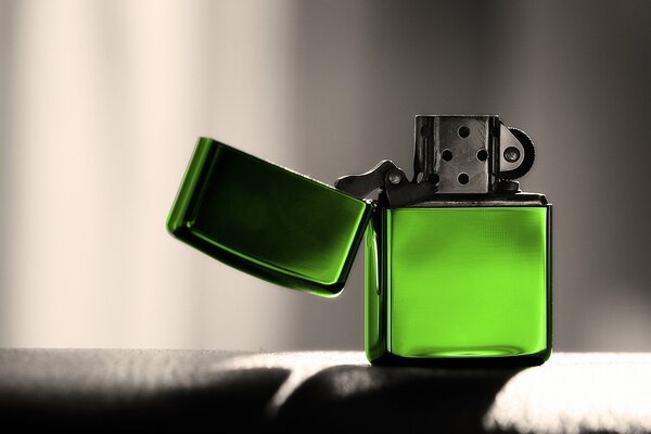 Green lighter on a gray background