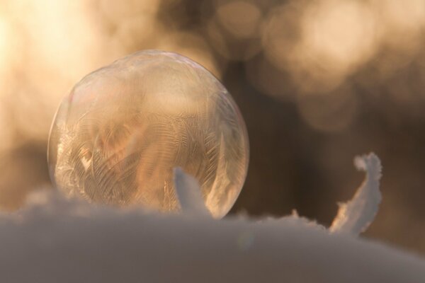 Macro shot of a pattern on a frozen soap bubble in winter