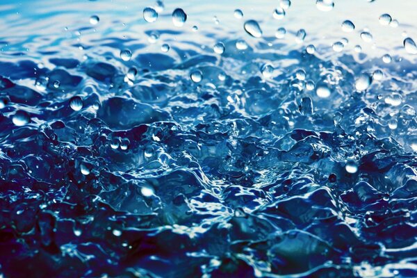 Drops and splashes on blue water